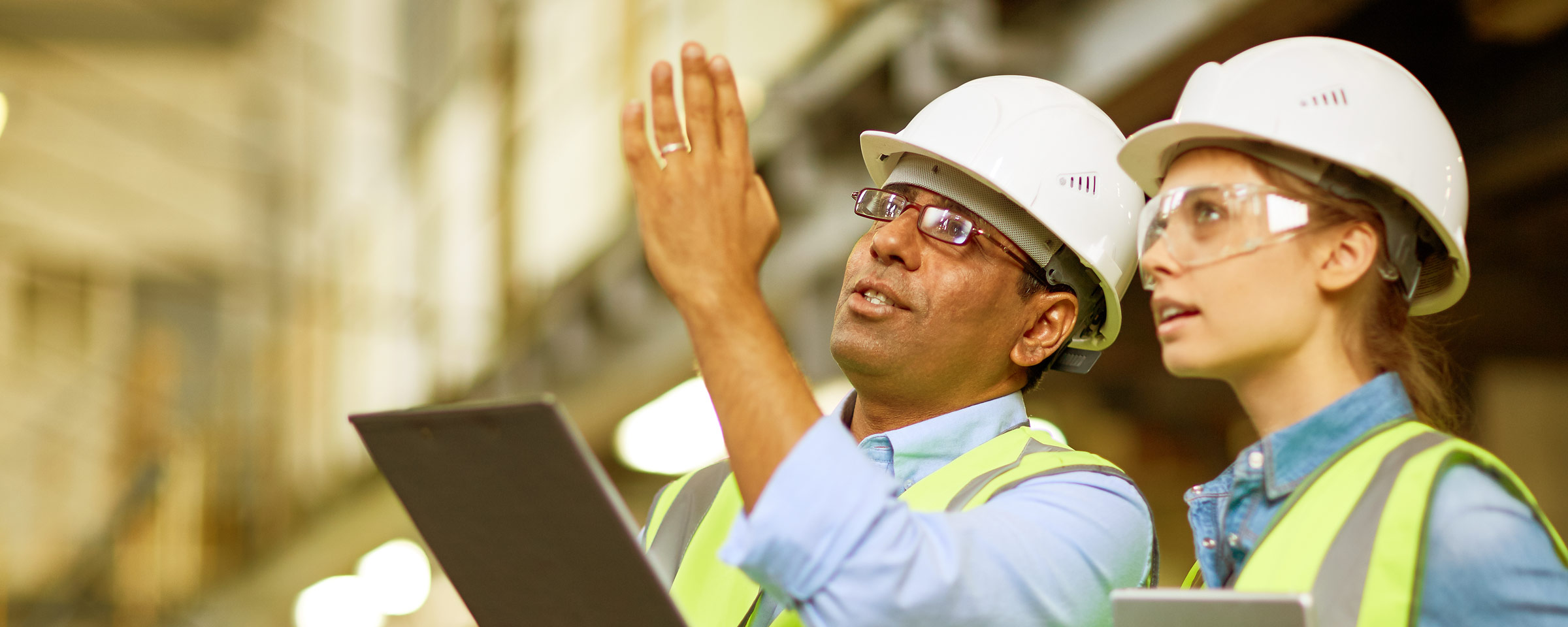 two engineers wearing white hard hats